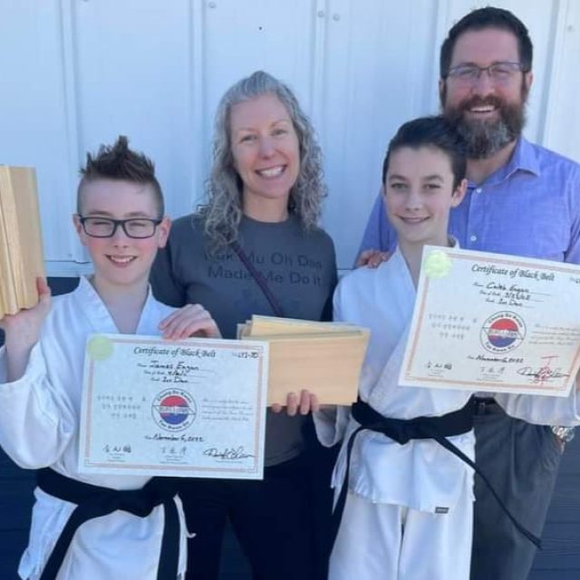 Young boys achieving a black belt