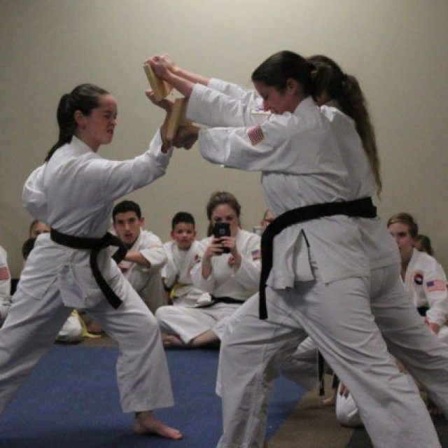 Female martial artist breaking a board